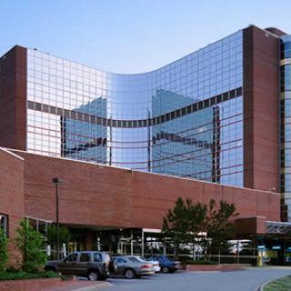 A modern architectural structure featuring a combination of glass and brick.