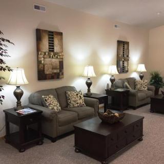 A cozy living room with plush sofas, elegant lamps, and tasteful wall art.
