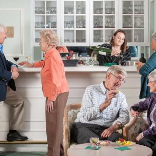 A group of seniors enjoying a social gathering in a cozy indoor setting.