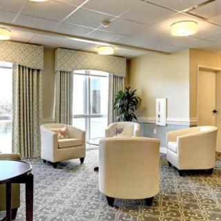 A well-lit lobby with comfortable seating and large windows.
