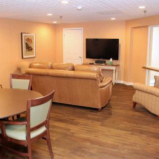 A cozy living room with sofas and a television.