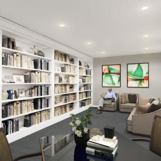 A modern library with cozy seating and extensive bookshelves.