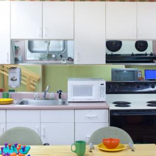 A modern kitchen setup with appliances and a dining table.