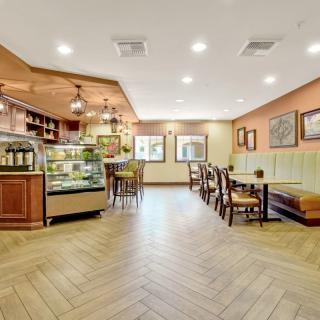 A cozy cafe interior with a seating area and display counter.
