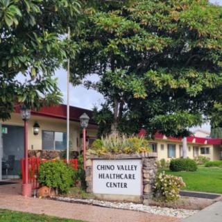 The exterior of Chino Valley Healthcare Center surrounded by trees and plants.
