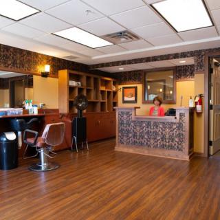 A well-organized salon interior with a reception desk and seating area.