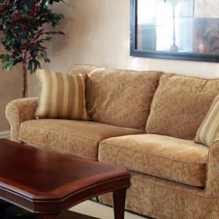 A cozy living room setting featuring a beige sofa and wooden coffee table.