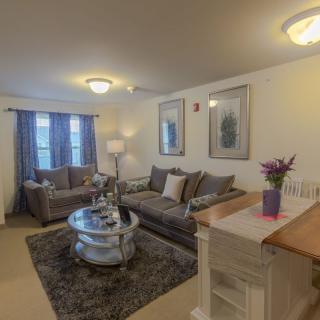 A cozy living room with comfortable seating and elegant decor.