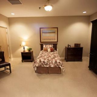 A cozy bedroom with a single bed and elegant decor.