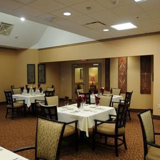 A well-arranged restaurant dining area with neatly set tables and comfortable chairs.