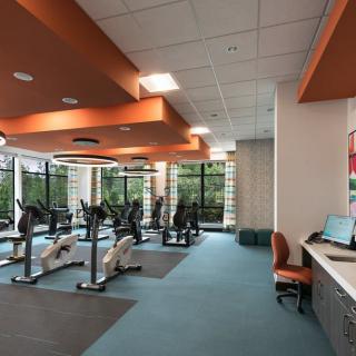 A modern gym interior featuring several treadmills and bright lighting.