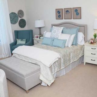 A modern and cozy bedroom with stylish decor and comfortable bedding.