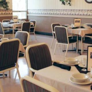 A cozy restaurant interior with neatly arranged tables and chairs, ready for dining.
