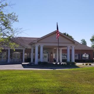 A welcoming entrance to a community building with a flag proudly displayed.