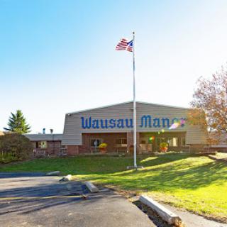 The exterior of a corporate building displaying the company name and an American flag.