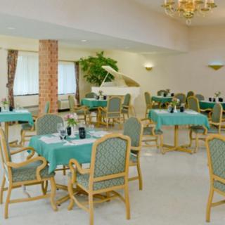 An elegant dining area with neatly arranged tables and chairs, featuring a sophisticated interior decor.