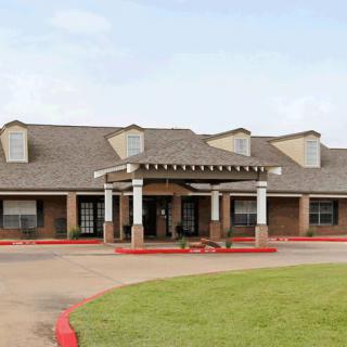 A building with a prominent entrance and landscaped surroundings.