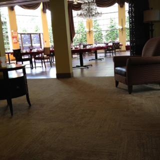 A cozy seating area with large windows and elegant furniture.