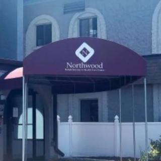 Entrance with a Northwood-branded awning.