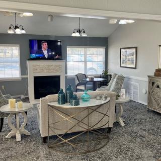 A cozy living room with a fireplace, TV, and comfortable seating.