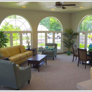 A bright and spacious living room with large windows and comfortable seating.