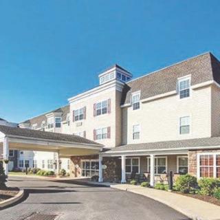 A multi-story residential building with a covered entrance.