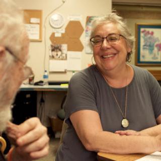 Two individuals engaged in a cheerful conversation, highlighting a moment of connection.