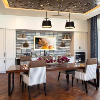 A modern dining room with elegant wooden furniture and stylish pendant lighting.