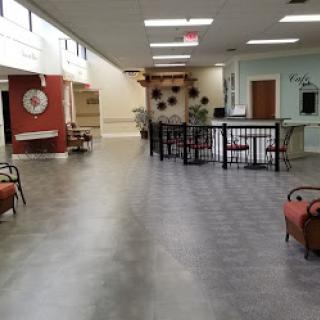 A spacious and modern interior hallway with seating arrangements and decorative elements.