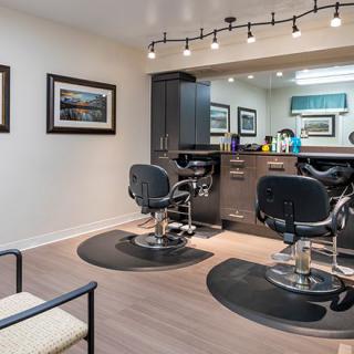 A modern hair salon interior with styling chairs and mirrors.