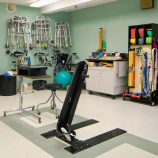 A physical therapy room equipped with various rehabilitation tools and equipment.