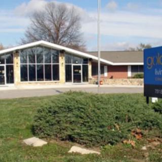 A church building with a prominent sign in the front yard.