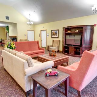 A cozy living room with comfortable seating and a large entertainment center.