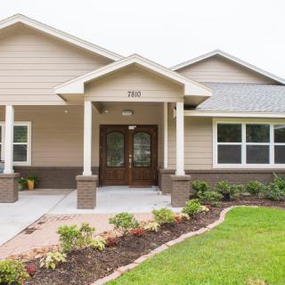 A suburban house with a landscaped front yard.