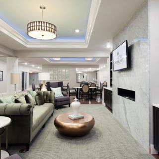A modern and luxurious open-concept living room with elegant furnishings and ambient lighting.