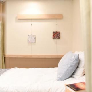 A minimalist bedroom with a neatly made bed and simple decor.