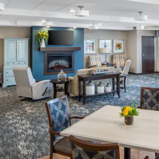 A cozy living room with a fireplace, comfortable seating, and elegant decor.
