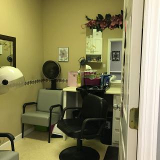 Cozy beauty salon interior with chairs and hair styling equipment.