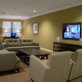 A modern living room with comfortable seating and a large television.