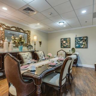 An elegantly decorated dining room with a formal table setting and stylish furnishings.