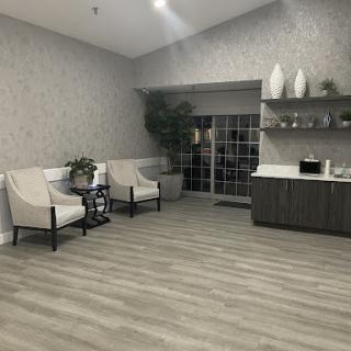 A spacious and modern lobby area featuring comfortable seating, decorative elements, and natural light.