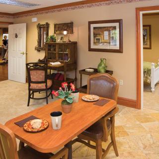 A cozy dining area with elegantly set tables and warm decor.