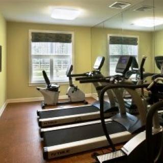 A gym room with treadmills and exercise bikes.