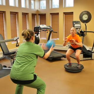 Two women engaged in a fitness workout focusing on balance and coordination.