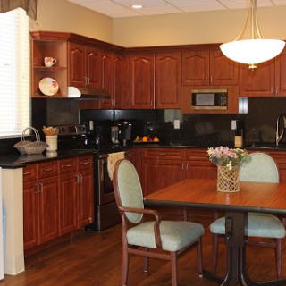 A modern kitchen featuring wooden cabinets and a cozy dining area.