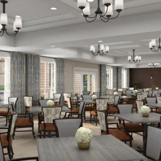 A spacious, elegantly designed dining room with neatly arranged tables and chairs, featuring decorative chandeliers and large windows adorned with curtains.