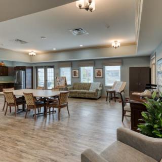 A spacious and modern living and dining area with comfortable seating and natural lighting.