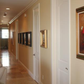 A well-decorated hallway featuring several framed paintings and artwork.