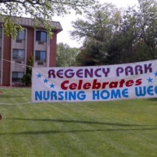 A banner in front of a building celebrating Nursing Home Week at Regency Park.
