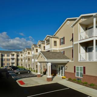 A modern residential apartment building under a clear blue sky.